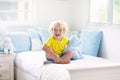 Child playing in bed. Kids room. Baby boy at home Royalty Free Stock Photo