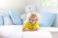 Child playing in bed. Kids room. Baby boy at home Royalty Free Stock Photo