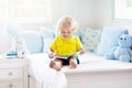 Child playing in bed. Kids room. Baby boy at home Royalty Free Stock Photo