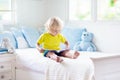 Child playing in bed. Kids room. Baby boy at home Royalty Free Stock Photo