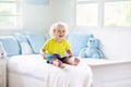 Child playing in bed. Kids room. Baby boy at home Royalty Free Stock Photo