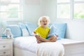 Child playing in bed. Kids room. Baby boy at home Royalty Free Stock Photo