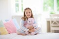 Child playing in bed. Kids room. Girl at home Royalty Free Stock Photo