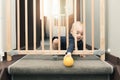child playing behind safety gates in front of stairs Royalty Free Stock Photo