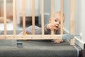Child playing behind safety gates in front of stairs Royalty Free Stock Photo