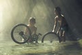 Child playing with bicycle in the creek Royalty Free Stock Photo