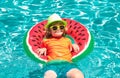 Child playing in blue water with swimming ring. Happy child playing in swimming pool. Summer kids vacation. Royalty Free Stock Photo