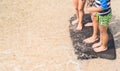 Child playing board on beach. Child imagine to be surfer.Three c Royalty Free Stock Photo