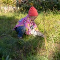Child playing with a cat in the grass Royalty Free Stock Photo