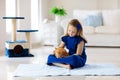 Child playing with cat at home. Kids and pets Royalty Free Stock Photo