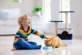 Child playing with cat at home. Kids and pets Royalty Free Stock Photo