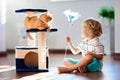 Child playing with cat at home. Kids and pets Royalty Free Stock Photo