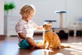 Child playing with cat at home. Kids and pets Royalty Free Stock Photo