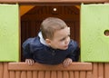 Child playing in a children playhouse. Royalty Free Stock Photo