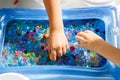 child playing with colored glass ball, playing game with colored balls Royalty Free Stock Photo