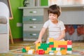 Child playing with colorful toy blocks. Little boy building tower at home or day care. Educational toys for young children. Royalty Free Stock Photo