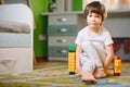 Child playing with colorful toy blocks. Little boy building tower at home or day care. Educational toys for young children. Royalty Free Stock Photo