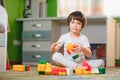Child playing with colorful toy blocks. Little boy building tower at home or day care. Educational toys for young Royalty Free Stock Photo