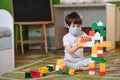 Child playing with colorful toy blocks. Little boy building tower at home or day care. Educational toys for young Royalty Free Stock Photo