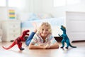 Child playing with toy dinosaurs. Kids toys Royalty Free Stock Photo