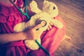 Child playing doctor or nurse with plush toy bear at home. Royalty Free Stock Photo