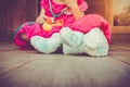 Child playing doctor or nurse with plush toy bear at home. Vintage tone effect. Royalty Free Stock Photo