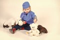 Child is playing doctor. small boy in doctor uniform playing vet with toy animal