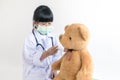 Child playing doctor with stethoscope and teddy bear Royalty Free Stock Photo