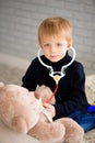 Child playing doctor with a toy. Pediatrician for preschool and kindergarten kids. Pediatric, healthcare and people