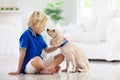 Child playing with dog. Kids play with puppy Royalty Free Stock Photo