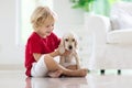 Child playing with dog. Kids play with puppy Royalty Free Stock Photo