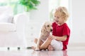 Child playing with dog. Kids play with puppy Royalty Free Stock Photo