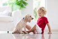 Child playing with dog. Kids play with puppy Royalty Free Stock Photo