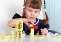 Child playing with dominoes
