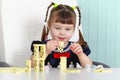 Child playing with dominoes at table Royalty Free Stock Photo