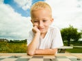 Child playing draughts or checkers board game outdoor Royalty Free Stock Photo