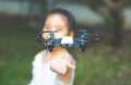 Child playing with drone outdoors at summer day