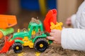 Child playing excavator on the street