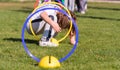 Child playing in a exercising circle - tunnel tube, crawling through it and having fun