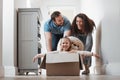 Child playing, father or mother pushing box in new house in a race or game for bond, love or happiness. Dad, playful mom Royalty Free Stock Photo