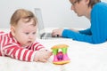 Child playing while father is working on laptop Royalty Free Stock Photo