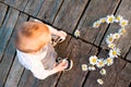 Child playing with flowers