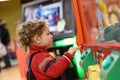 Child playing on game machine