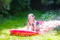 Child playing with garden water slide Royalty Free Stock Photo