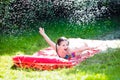 Child playing with garden water slide Royalty Free Stock Photo