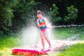 Child playing with garden water slide Royalty Free Stock Photo