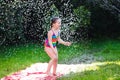 Child playing with garden water slide Royalty Free Stock Photo