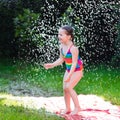 Child playing with garden water slide Royalty Free Stock Photo