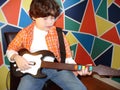 Child playing guitar Royalty Free Stock Photo