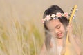 Child playing guitar to meadow in nature on sunny day Royalty Free Stock Photo